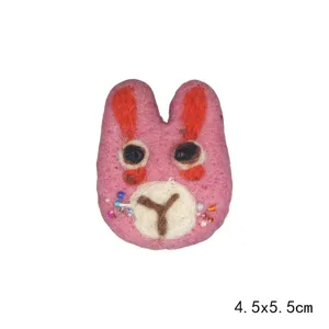 Handmade cute felt rabbit brooch detail view, lovely wool animal accessory item.