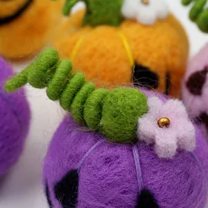 Handmade wool felt Halloween pumpkin detail view, perfect for holiday decor and accessories.
