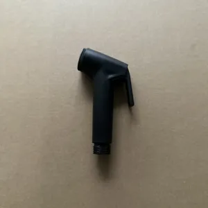 Black plastic bidet sprayer nozzle for toilet bathroom cleaning, handheld flush wash tool.