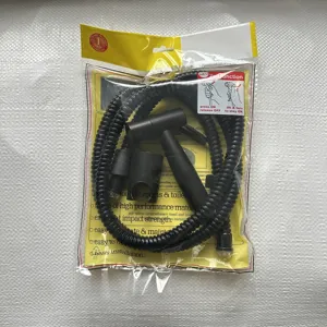 Close-up of black plastic bidet sprayer hose and holder set for bathroom toilet cleaning.