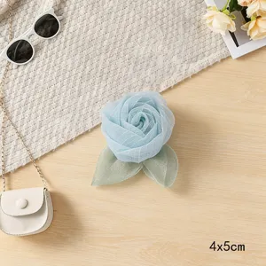 Blue mesh rose fabric flower accessory with leaves for hair decor and DIY apparel crafting.