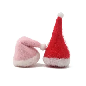 Close-up detail of cute mini felt Christmas hats, perfect for DIY holiday crafts and decor.