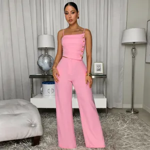 Pink two piece set detail featuring stylish camisole top with gold buttons and wide leg pants.