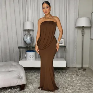 Detailed view of brown strapless ruched fishtail evening dress worn in luxury setting.