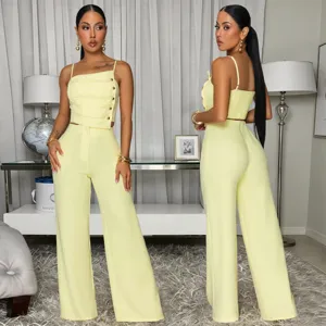 Elegant yellow camisole and wide-leg pants two-piece set with chic metal buttons and pleats.