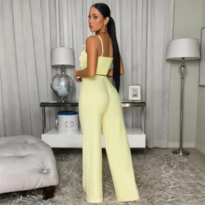 Yellow two-piece set featuring a cropped cami top with metal buttons and wide leg pants.