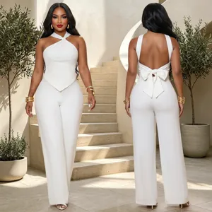 Close-up detail showing the elegant white halter twist top and wide leg pants set.