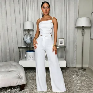 Detail view of women's solid asymmetric strap top and wide-leg trousers two-piece set.