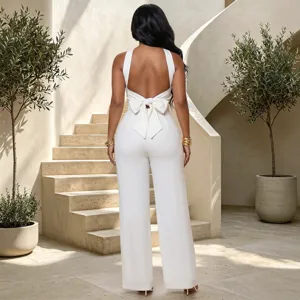 Elegant white backless jumpsuit featuring a charming bow detail on the back and wide-leg cut.