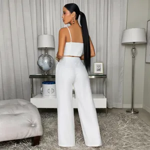 Elegant white two-piece set featuring a cropped camisole top and wide-leg trousers.