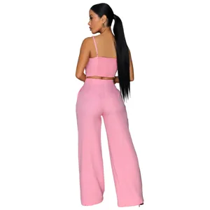 Back view of pink camisole and wide leg pants set detail showing pleats and buckle.