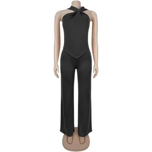 Black halter neck sleeveless top paired with matching wide leg trousers detail view.