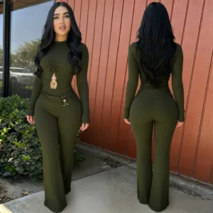 Dark green ribbed long sleeve cutout jumpsuit detail showing high waist and flared leg fit.