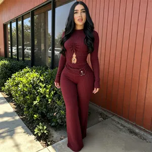 Detail shot of the stylish ribbed long-sleeve cutout jumpsuit showcasing metal ring accents.