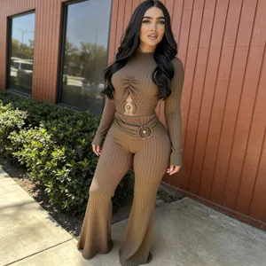 Detail view of the ribbed cutout long-sleeve top and high-waist flare pants set outdoors.