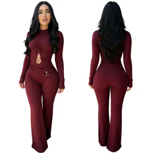 Ribbed knit long sleeve jumpsuit detail, cutout front with metal ring, high waist flare leg.
