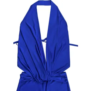 Close-up detail of the royal blue halter neck deep-V crossover romper and waist knot.