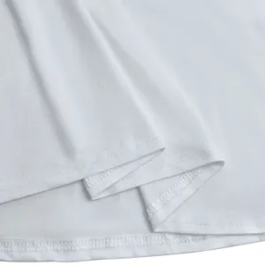 White dress fabric detail close-up showcasing fine stitching and smooth texture.