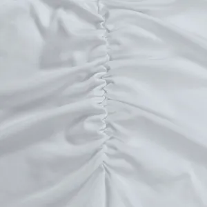 White evening dress fabric detail close-up, premium ruched texture for party gowns.