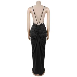 Back view detail of the elegant black evening dress featuring crisscross straps and ruching.