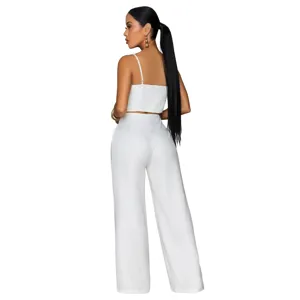 Detail view of the white two-piece set featuring a crop top and wide-leg trousers.