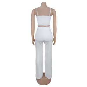 Detailed back view of the solid white smocked camisole and wide leg pants two piece set.