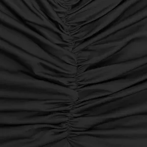 Close-up detail of black ruched dress fabric, showing exquisite gathering and texture.