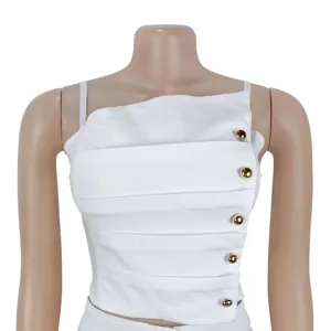 Detailed view of white pleated camisole top with stylish gold metal buttons for women.