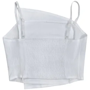 Close-up detail of white camisole top showing back smocking texture and delicate straps.