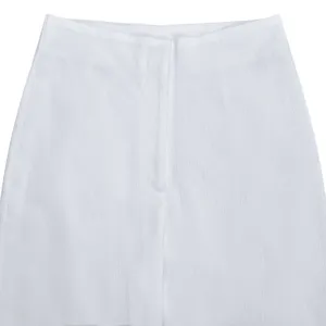 Detail shot of women's white crinkled wide-leg trousers waistband and front fly design.