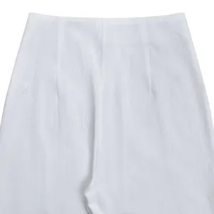 Detail view of women solid color crinkled high waist wide leg pants fabric texture.