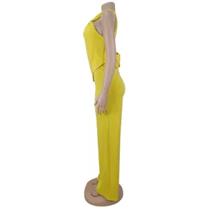 Yellow twist crop top wide leg pants set side view showcasing garment details and silhouette.