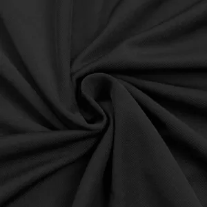 Close-up detail of smooth black fabric showing soft texture and elegant drape quality.