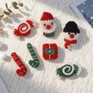Close up of handmade crochet Christmas accessories, cute mini Santa, snowman and candy decor.