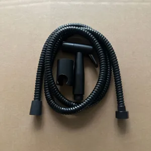 Black plastic bidet sprayer set detail shot, showing handheld nozzle, hose and holder.