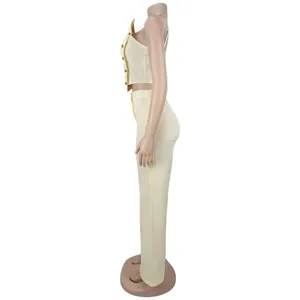 Side view of yellow camisole top and wide leg pants set with metal buttons detail.