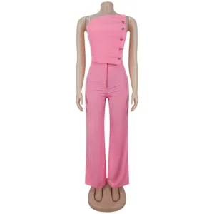 Pink two-piece set featuring a pleated top with metallic buttons and matching wide-leg pants.