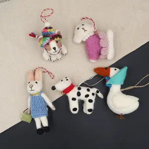 Closeup of handmade wool felt animal pendants, cute cartoon puppy and rabbit keyring charms.