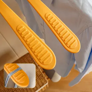 Wide shoulder plastic clothes hanger with non-slip rounded stripes for home wardrobe use.