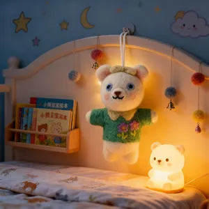 Detailed view of a cute wool felt bear plush pendant hanging on a warm children bed headboard.