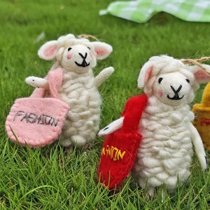 Handmade wool felt cute sheep keychain detail view, decorative plush bag pendant craft.