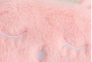 Pink plush sleep mask detail view, soft rabbit fur texture with cute embroidered closed eyes.