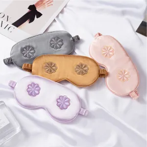 Silk sleep mask with 3D floral embroidery, breathable and comfortable for travel and home use.