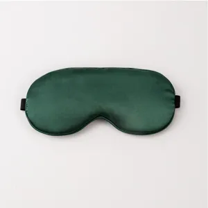 Silk sleep mask detail shot, breathable satin eye mask for sleeping, deep green night shade.