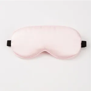 Silk sleep mask detail, smooth pink satin fabric texture close-up for comfortable daily resting experience.