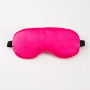 Close-up detail of smooth bright pink imitation silk sleep mask with black elastic strap.