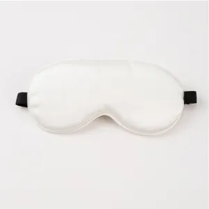 Close-up detail shot of a smooth white imitation silk sleep mask with black elastic strap for nap.