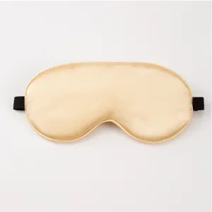 Detail view of champagne silk sleep mask, smooth satin texture for comfortable night sleep.