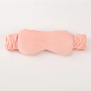 Pink plush 2-in-1 headband and sleep eye mask detail view, soft velvet fabric texture.
