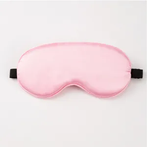Pink silk eye mask detail, soft breathable fabric with elastic strap for comfortable sleep.